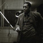 John Coltrane at the recording sessions for <em>A Love Supreme</em>. In addition to the images already published, photographer Chuck Stewart recently unearthed never-before-seen shots of the session, including this one. Per the request of Chuck Stewart's family, reproduction of these photos elsewhere is prohibited.