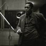 John Coltrane at the recording sessions for <em>A Love Supreme</em>. In addition to the images already published, photographer Chuck Stewart recently unearthed never-before-seen shots of the session, including this one. Per the request of Chuck Stewart's family, reproduction of these photos elsewhere is prohibited.