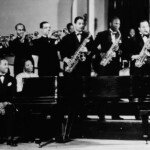 Andy Kirk And His Orchestra, including Mary Lou Williams (sitting at the piano), pose for a studio group portrait in 1940. Williams toured with Kirk's band before settling in New York.