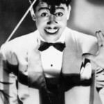 circa 1935:  Portrait of American bandleader Cab Calloway (1907 - 1994) holding a baton in a light-colored jacket and bow tie.  (Photo by Frank Driggs/Frank Driggs Collection/Getty Images)