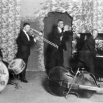 1922: A Kid Ory band in California including Warren "Baby" Dodds, Ory, Mutt Carey, Edward Garland and Wade Whaley.