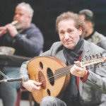 Iraqi musician Naseer Shamma plays the oud during rehearsals at the Iraqi National Theater in Baghdad on January 17, 2022. Long uprooted from his native Iraq, Shamma, an icon of the Arabic oud, has returned home to help rekindle the flame of Iraqi music, snuffed out by decades of conflict. (Photo by AHMAD AL-RUBAYE / AFP)